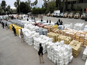 Members of the Mexican Federal Police guard over 105 tonnes of marijuana on October 18, 2010 in the border town of Tijuana, Mexico, seized after a clash with drug traffickers in the largest such seizure in recent years, the military said. Over 10,000 packages of marijuana were seized, weighing in at some 105 tonnes. Eleven people were arrested in the operation.  AFP PHOTO / FRANCISCO VEGA