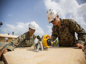 U.S. Marine Corps Lance Cpl. Kendra Hazelwood, left, a combat engineer with Special Purpose Marine Air-Ground Task Force-Southern Command and Pfc. Jared Colvin, a combat engineer with SPMAGTF-SC, saw wood for Jardin de Niños: El Porvenir, a reconstructed school, in Puerto Lempira, Honduras, July 28, 2015. SPMAGTF-SC is a temporary deployment of Marines and Sailors throughout Honduras, El Salvador, Guatemala, and Belize with a focus on building and maintaining partnership capacity with each country through shared values, challenges, and responsibility. (U.S. Marine Corps Photo by Cpl. Katelyn Hunter/Released).